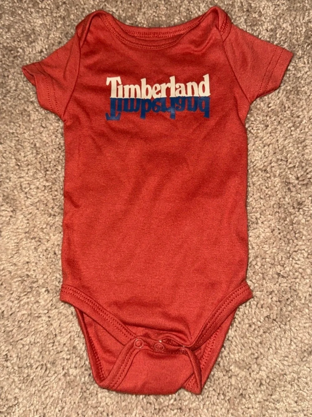 Timberland baby bodysuit with white and blue logo